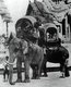 Thailand: Elephants caparisoned with howdahs carry the young princes in the courtyard of the Grand Palace in Bangkok, late-19th century.