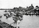 Thailand: A rower approaches a floating market near Bangkok, c. 1900.