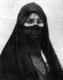 Algeria: Veiled Arab beauty, c. 1910.